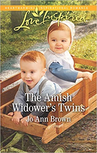 Boy/Girl Amish Twins sitting in a wagon in the grass, Love Inspired July 2019 - The Amish Widower's Twins by Jo Ann Brown